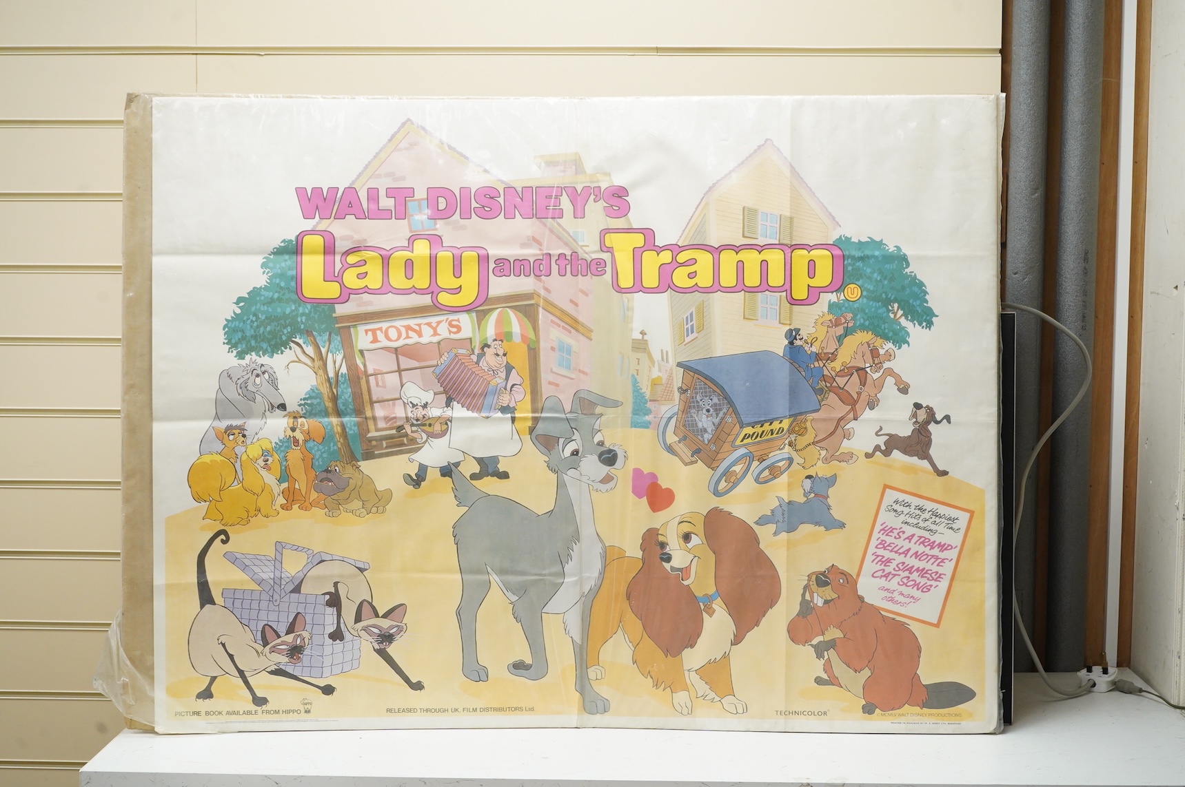 A vintage Lady and the Tramp film poster, copyright MCMLV, printed in England by W. E. Berry, unframed, 76 x 100cm